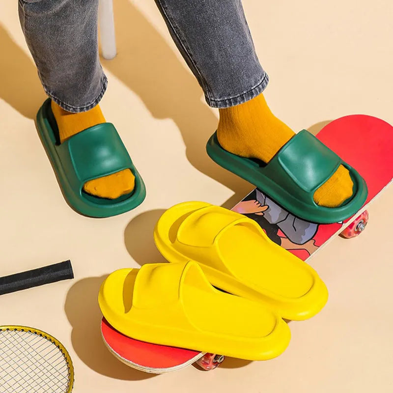 Pair of thick-soled white EVA flip-flop slippers with a non-slip patterned sole.
