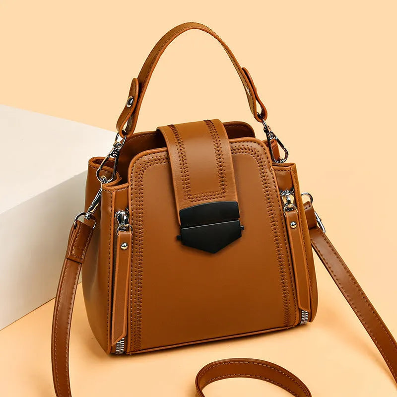 Small square vertical women's handbag in soft textured PU leather, shown in multiple colour options.