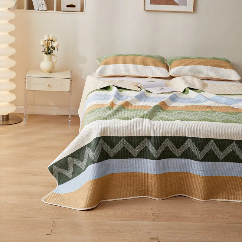 Pure cotton printed bed sheet three-piece set laid out on a bed, showing a modern pattern.
