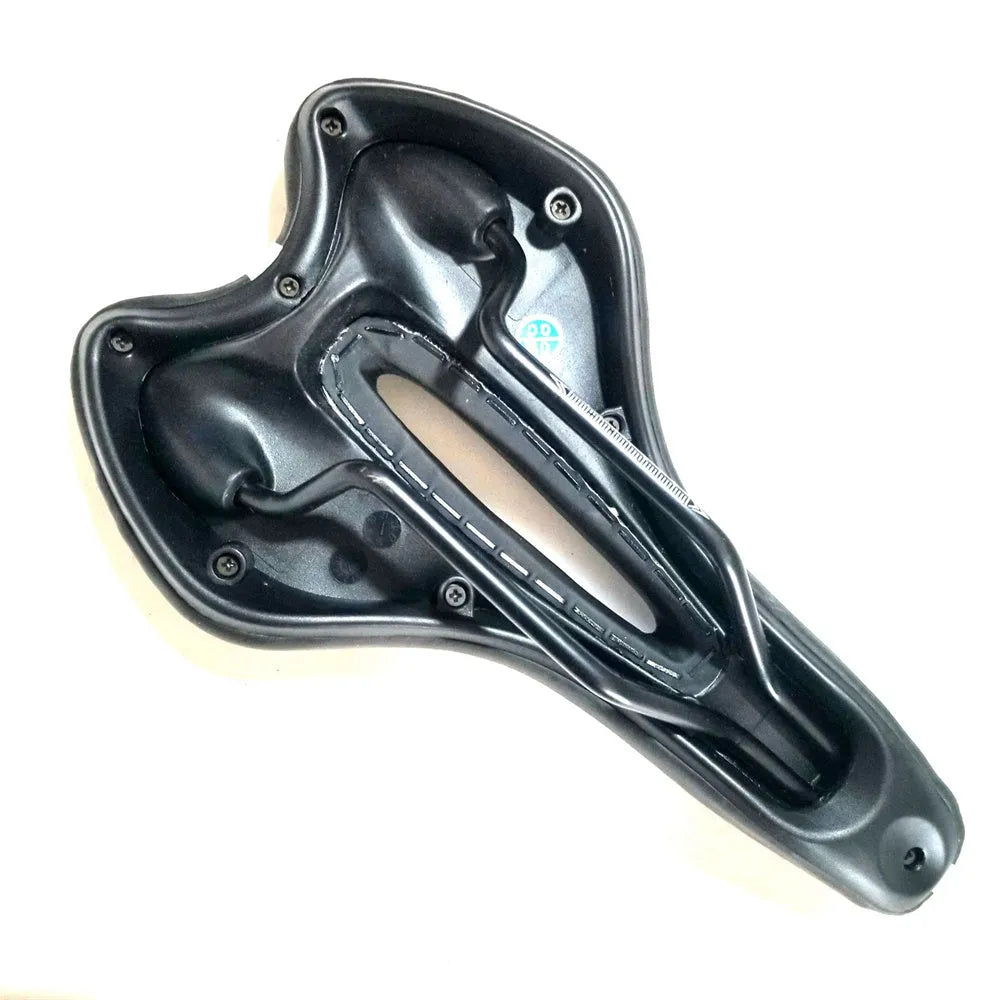Black bicycle saddle with silicone padding and two visible steel springs underneath, shown with a waterproof cover and tools.