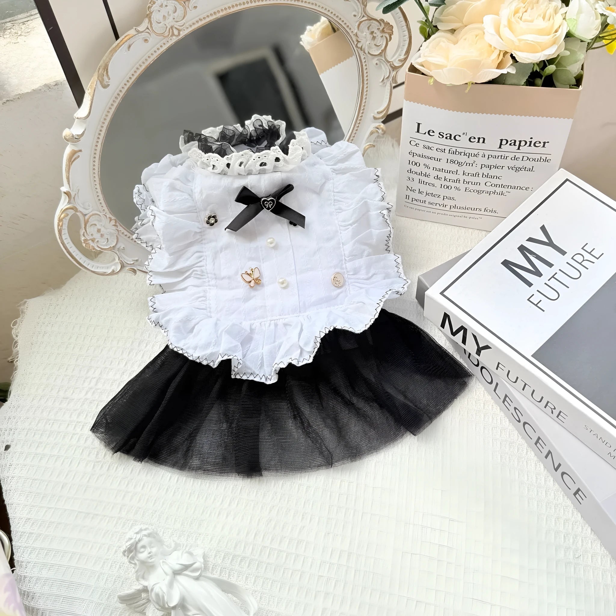 White yarn-trimmed polyester gauze skirt for a small dog on a mannequin, showing princess style.
