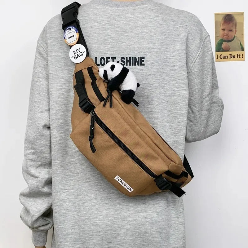 Trendy chest bag for men in Oxford cloth with letter pattern, adjustable strap, and two random badges on a plain background
