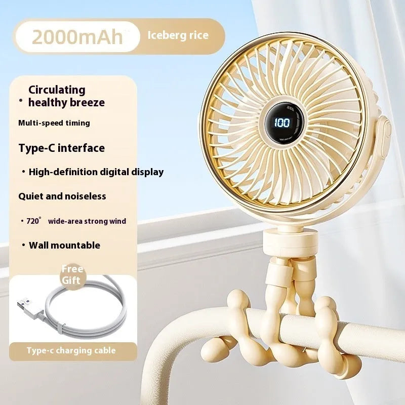 A beige portable clip-on fan with three blades, mounted on a stroller handle, showing its rotating head.
