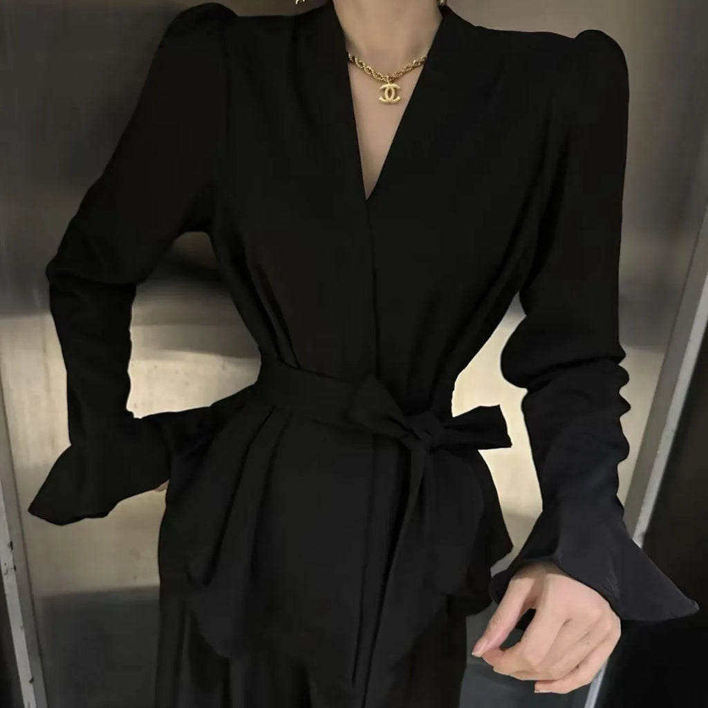 Black women's French-style shirt with irregular collar, long bell sleeves and tied front detail.
