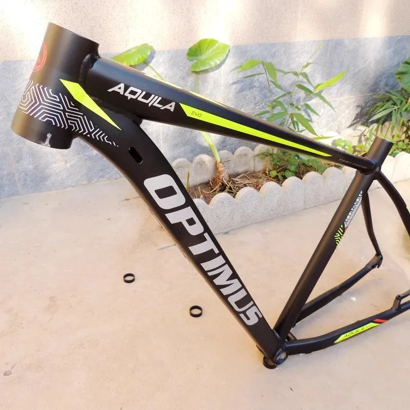 Black green aluminium mountain bike frame for 29-inch wheels with internal cable routing and disc brake mount.