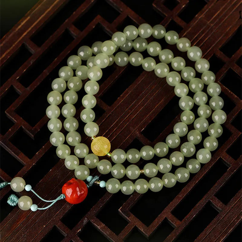 Pale blue Hetian jade bracelet with 6mm beads in three-circle design on wrist