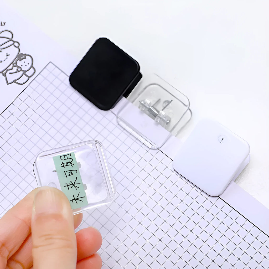 Square plastic photo memo holder in black, white, or transparent on a desk.