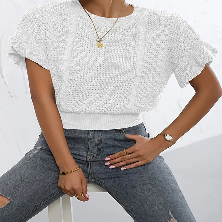 White twisted string knitted pullover sweater with ruffled short sleeves on a hanger.