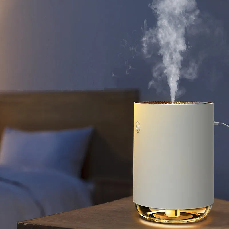 White, pink, or green night light humidifier and essential oil diffuser unit on a bedside table