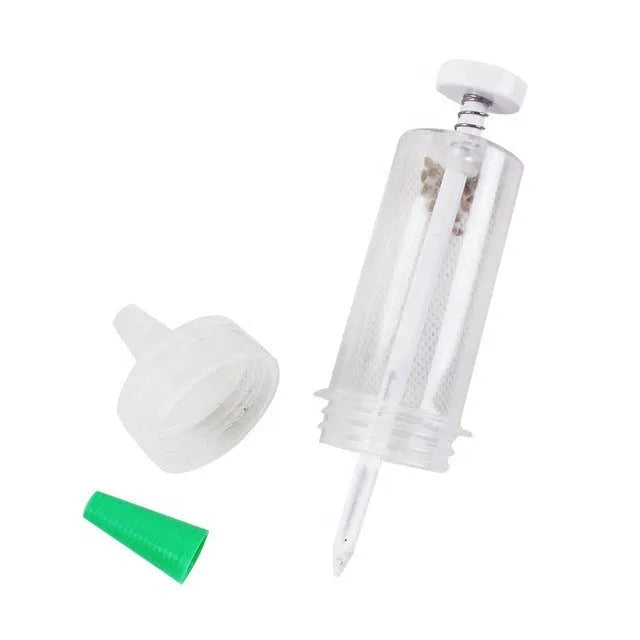 Plastic mini garden seeder tool measuring 12cm long for precise seed planting in pots