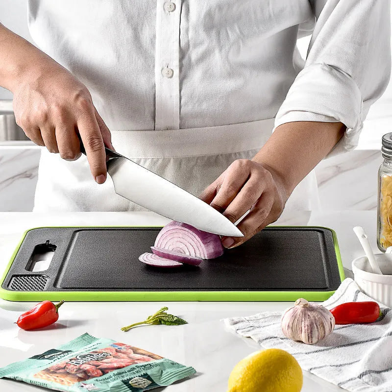 Grey square aluminium kitchen chopping board with double cutting sides, defrosting function and built-in knife sharpener