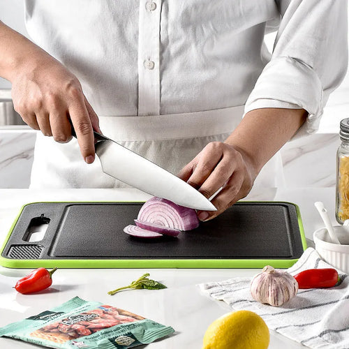 Grey square aluminium kitchen chopping board with double cutting sides, defrosting function and built-in knife sharpener