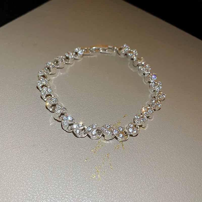 Silver metal bracelet with heart shape and inlaid zircon stones for women