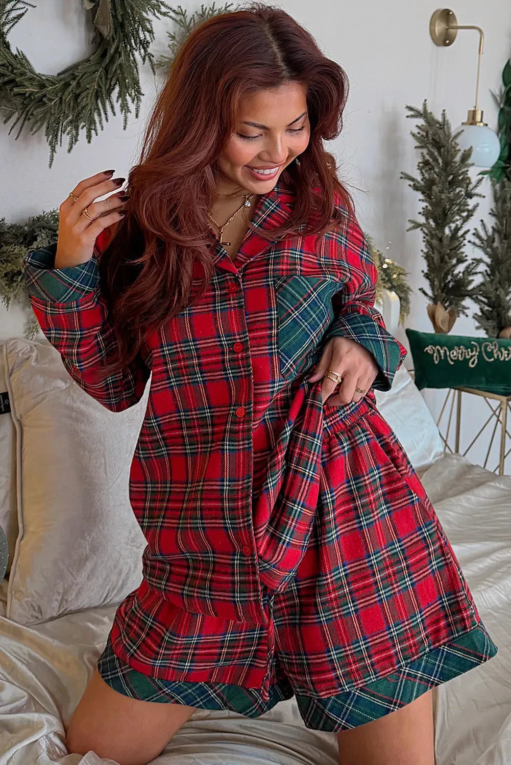 Red plaid Christmas pyjama set with contrast patches, showing long sleeve shirt and shorts laid flat.