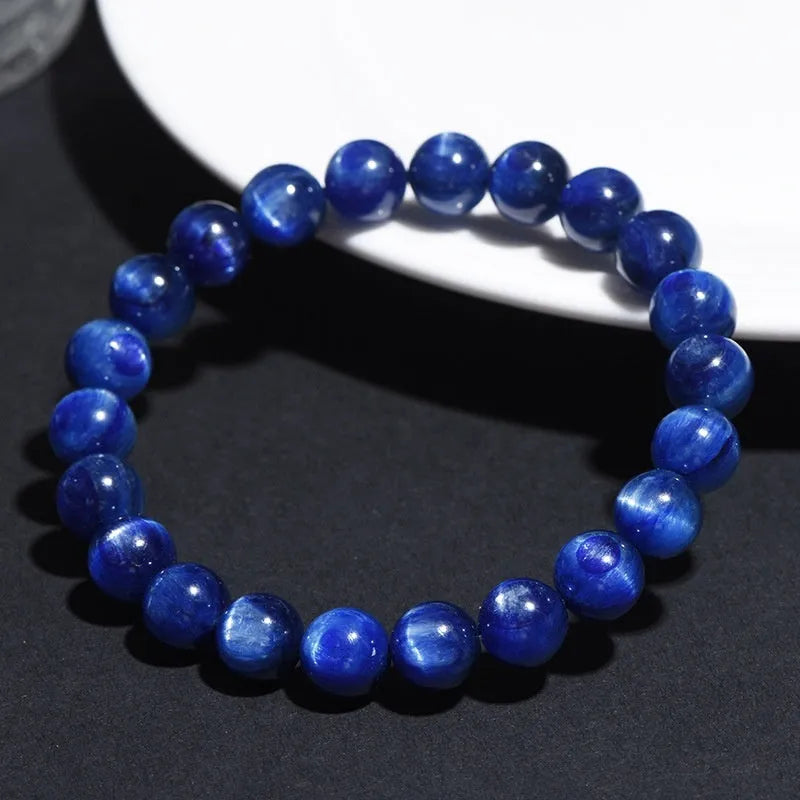 A polished blue crystal bracelet with geometry-shaped beads and a Ruyi charm on a single circle.