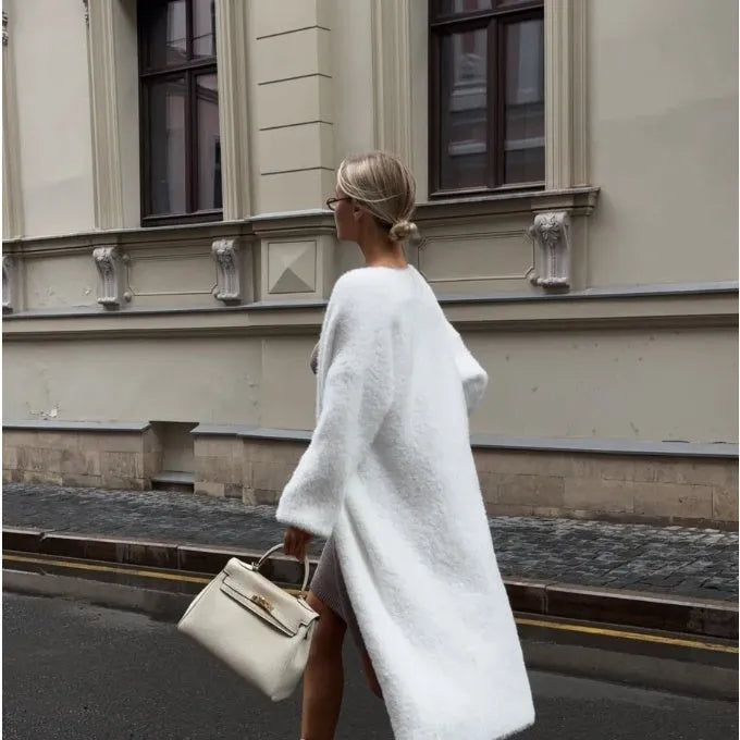 White long sleeve knitted cardigan jacket with a loose fit and extended length.