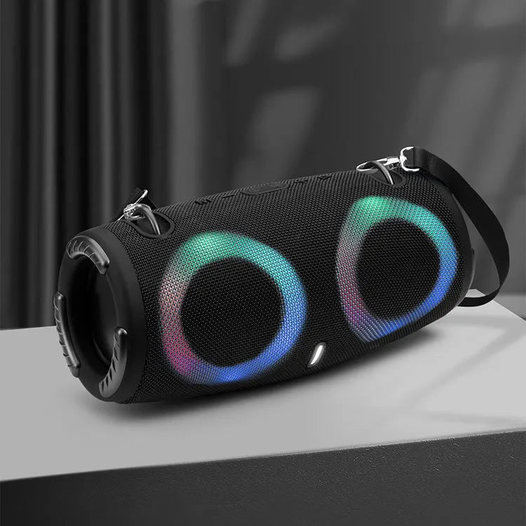 War Drum portable Bluetooth speaker in camouflage colour with dynamic RGB lights, showing carrying strap and control buttons.