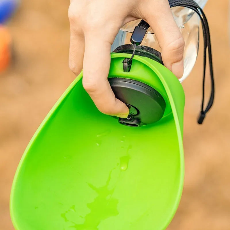 Blue portable pet water bottle with integrated drinking bowl, showing key lock mechanism.