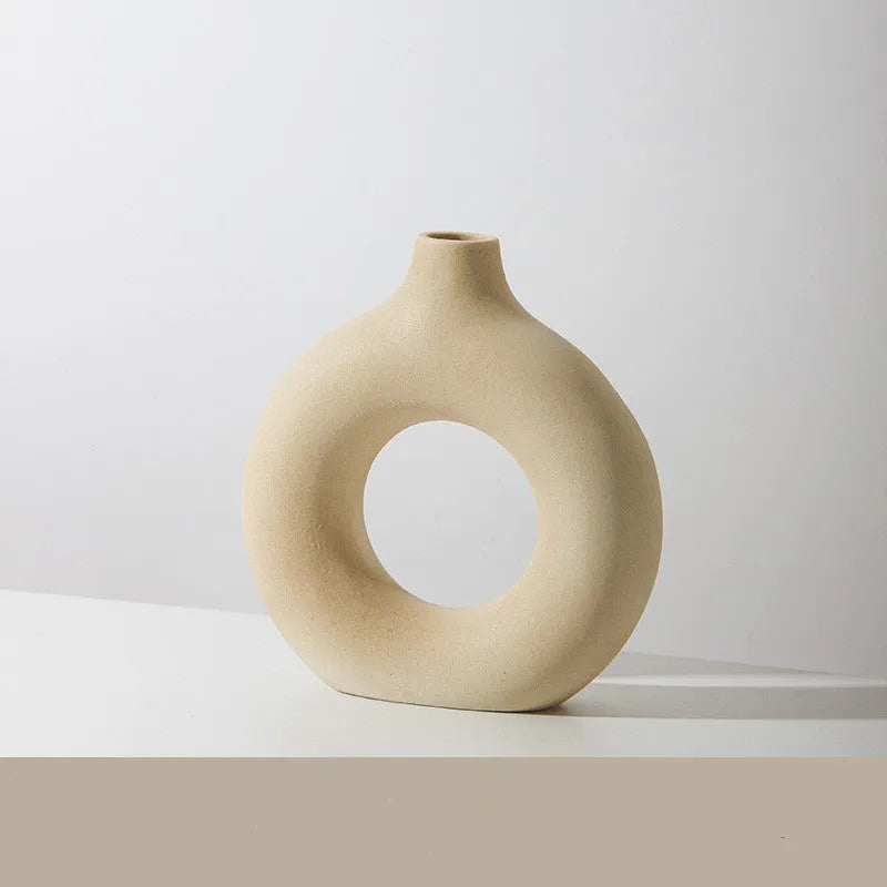 A simple modern frosted porcelain biscuit vase in a neutral colour, for flower arranging.