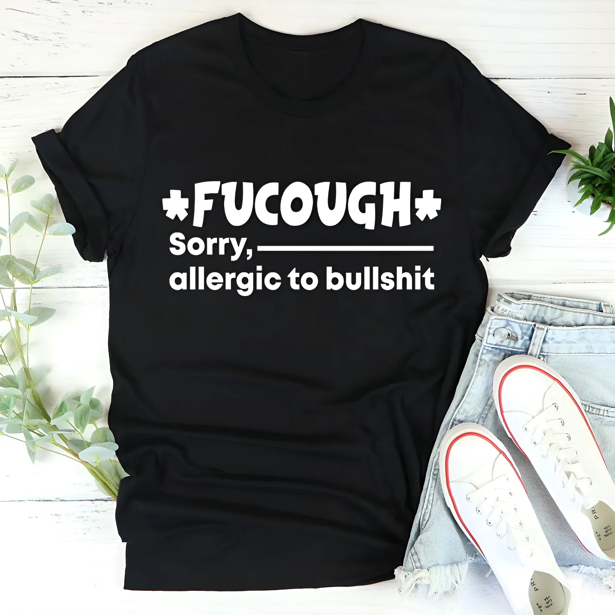 Black loose-fit cotton T-shirt with short sleeves and a round neck on a hanger