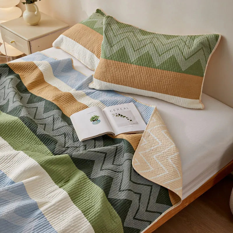 Pure cotton printed bed sheet three-piece set laid out on a bed, showing a modern pattern.
