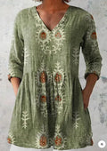 Women's printed loose dress with wide waist and three-quarter length sleeves on a hanger.
