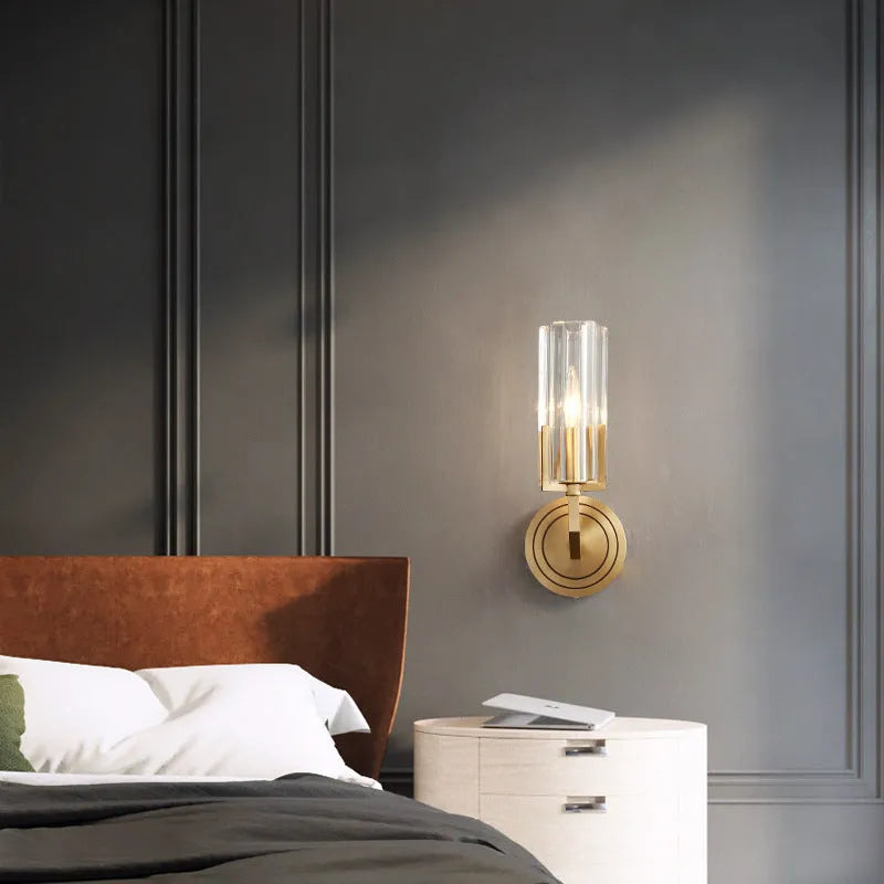 Modern minimalist copper wall lamp with single head on a white wall.