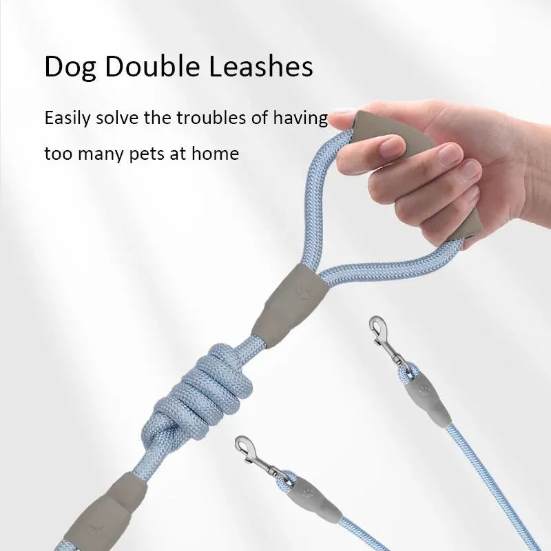Blue double dog leash for two small dogs with a soft foam handle and metal clips.