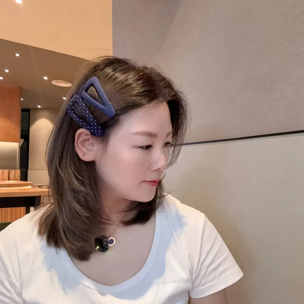 French retro style hair barrettes in triangle and water drop shapes with dark denim and polka dot patterns.