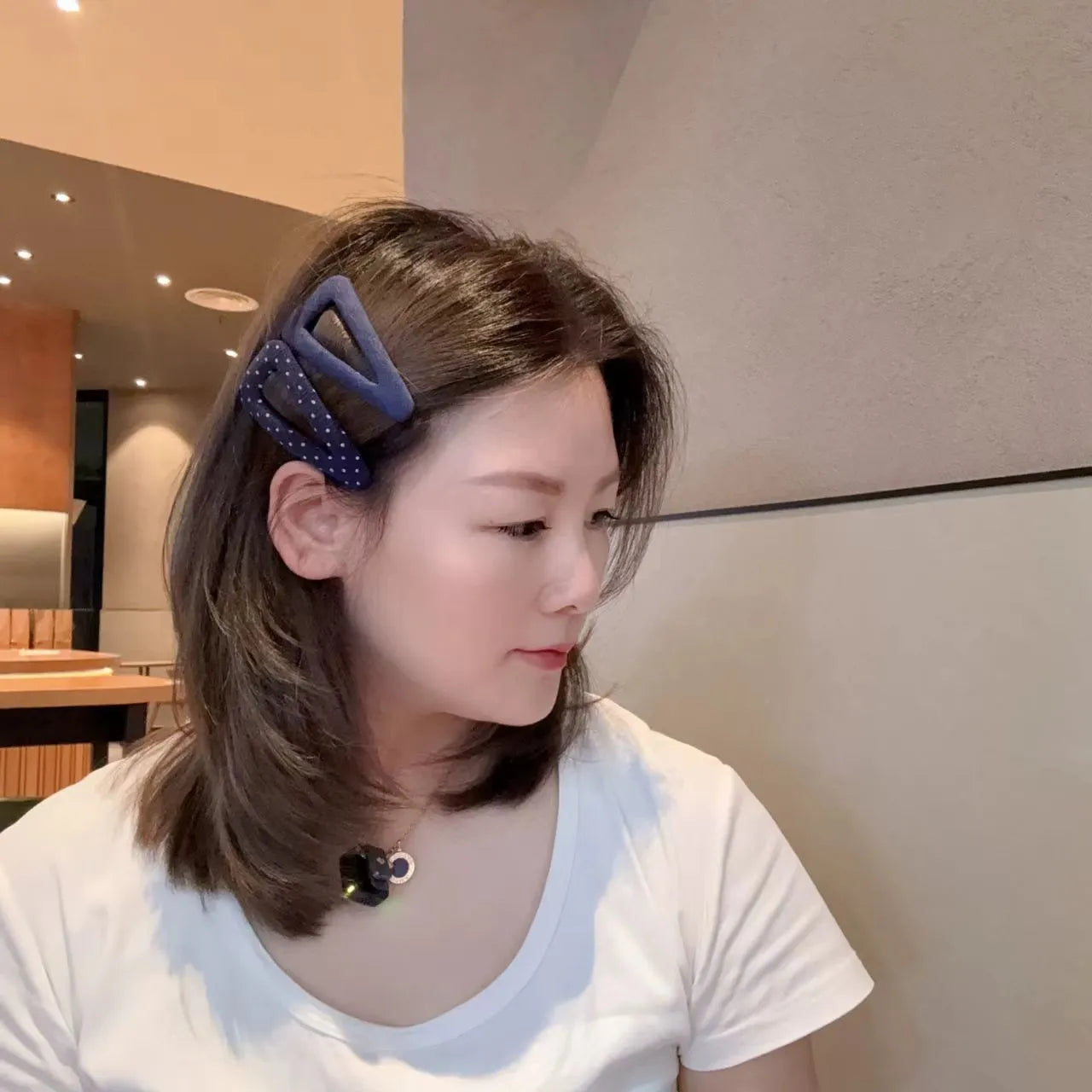 French retro style hair barrettes in triangle and water drop shapes with dark denim and polka dot patterns.
