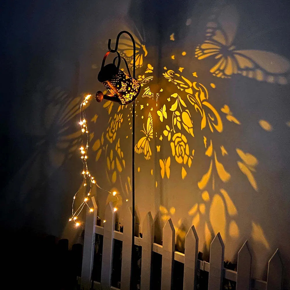 Solar-powered iron garden lamp with a tapered butterfly pattern emitting warm white light.