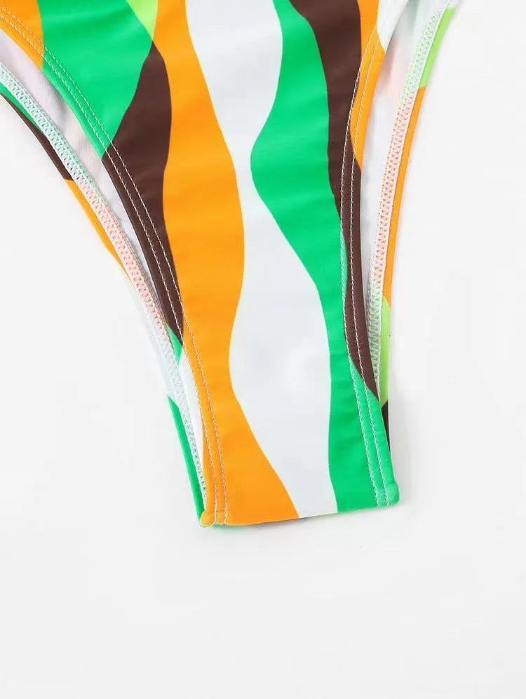 Women's yellow green three-piece bikini set with a beach skirt laid flat