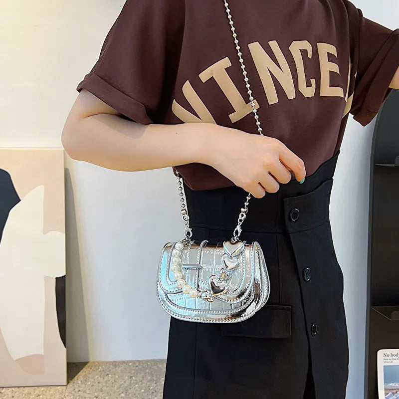 Silver women's PU leather mini saddle crossbody bag with square shape and single shoulder strap.