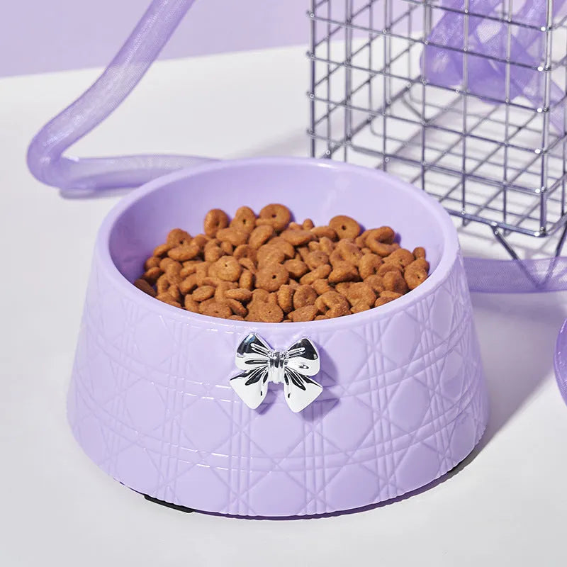 Pet food bowl with diamond pattern and bowknot decoration in black, purple or white with pink or silver bow