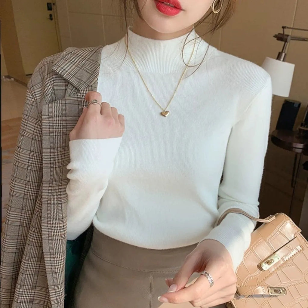 Women's slim fit knitted long sleeve shirt in viscose, shown in apricot colour.