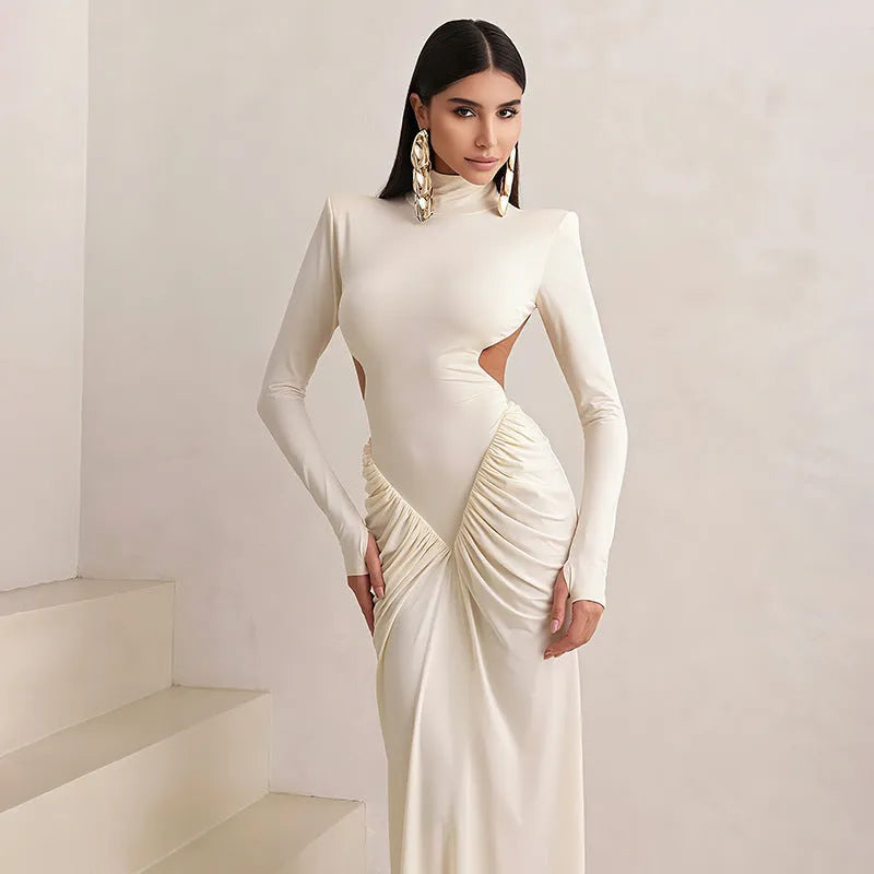 A woman's long sleeve high collar slim fit dress in a solid colour with a pleated backless detail.