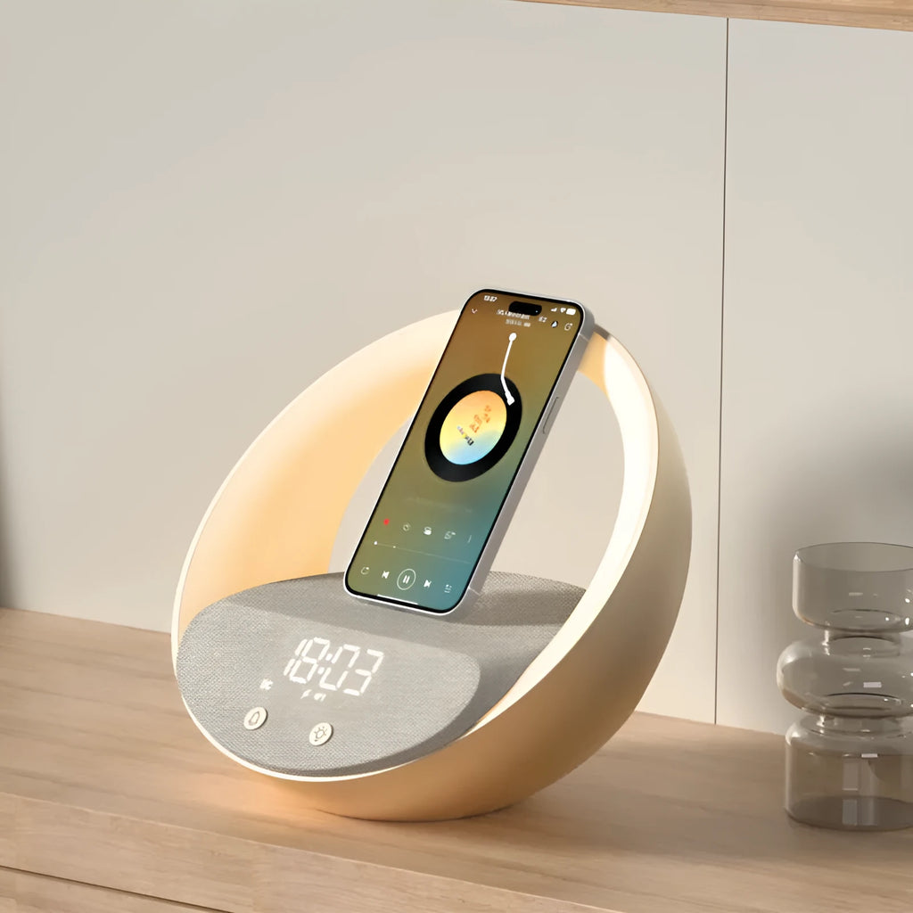 Beige multifunctional Bluetooth speaker with wireless charging surface and ambient LED lighting on bedside table