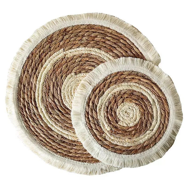 Round Japanese straw placemat with tassel edge on dining table