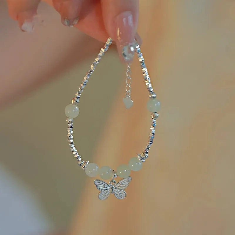 Copper bracelet and necklace set with silver electroplating and butterfly designs featuring Hetian jade accents
