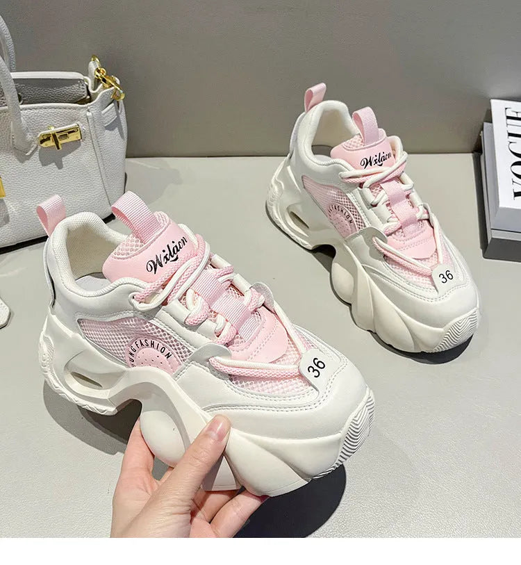 Women's beige casual sneakers with a cross strap and thick mid-heel sole.