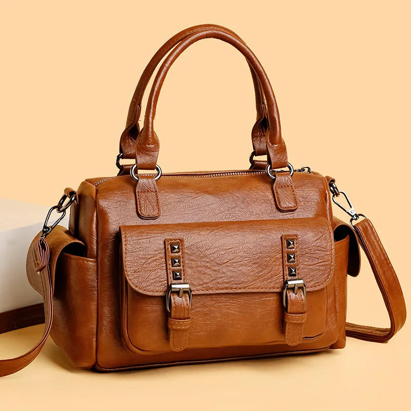 Large vintage-style messenger bag in a horizontal square shape, showing stitching detail, displayed in multiple colour options.