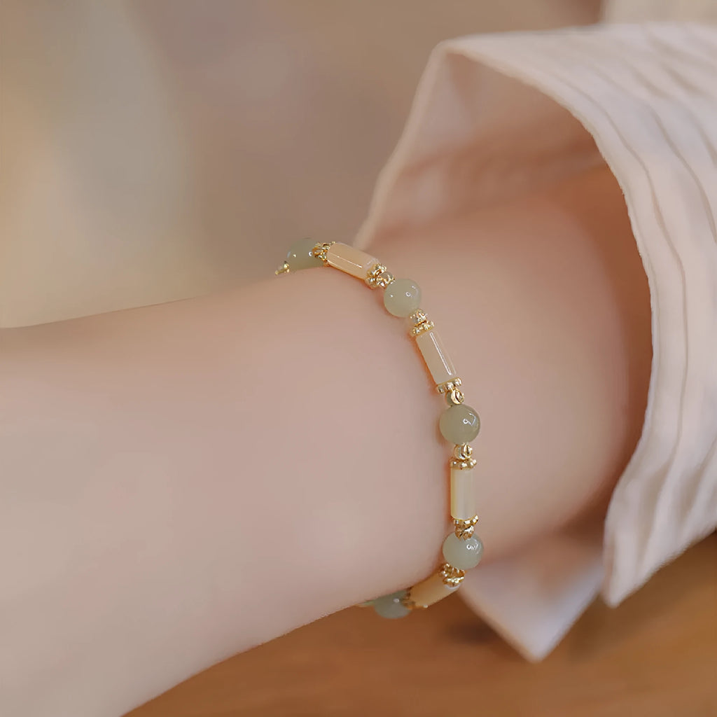 Women's bamboo joint bracelet with polished 6mm Hetian jade or South red agate beads.
