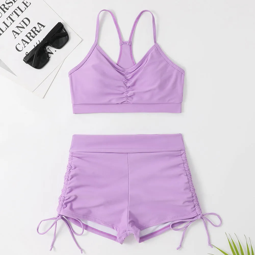Women's solid colour high-waisted bikini set with a sleeveless top, shown in purple.