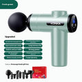 Konka V19 grey professional electric massage gun with set of eight different silicone massage heads on a table.