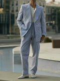 Blue and white striped men's polyester suit set with blazer and trousers on a model.