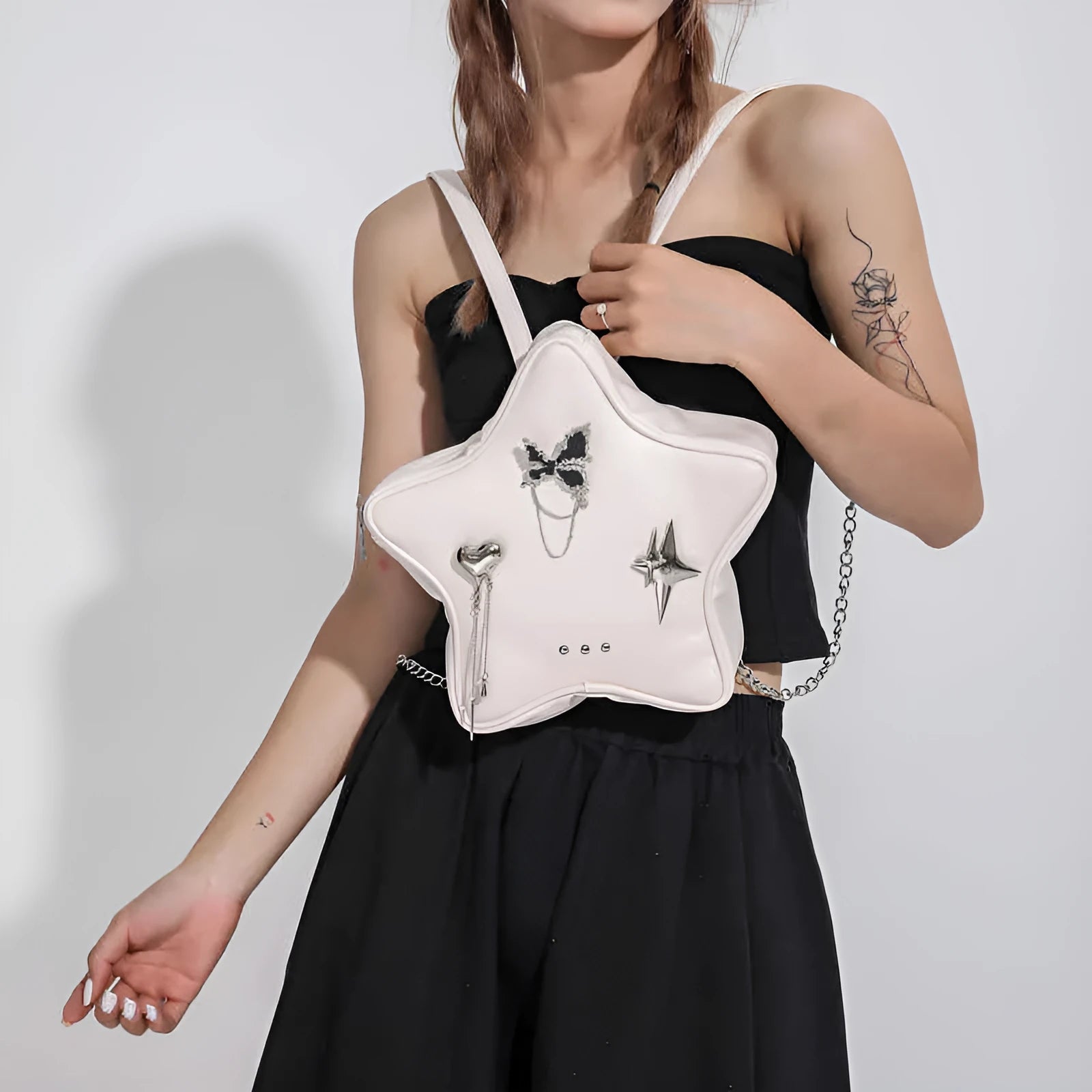 Soft black PU women's mini messenger bag worn as a backpack on a model.