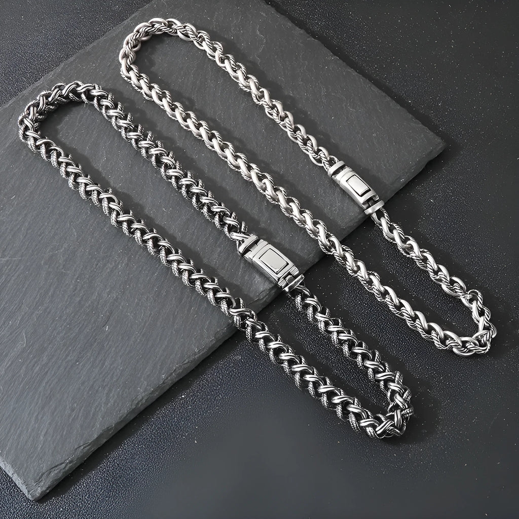 Men's keel twist titanium steel chain necklace in antique silver on a grey background