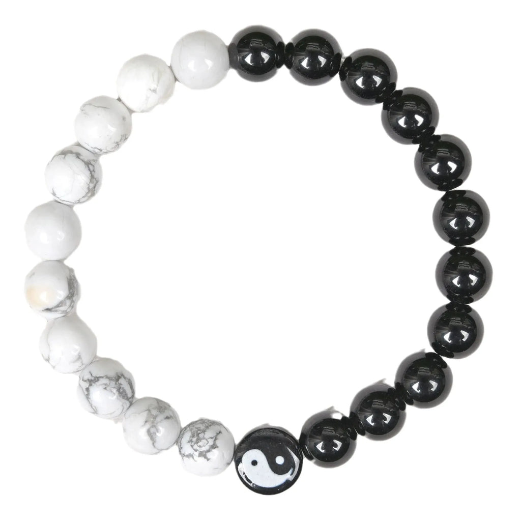 Natural obsidian and white turquoise 8mm bead bracelet on a neutral background