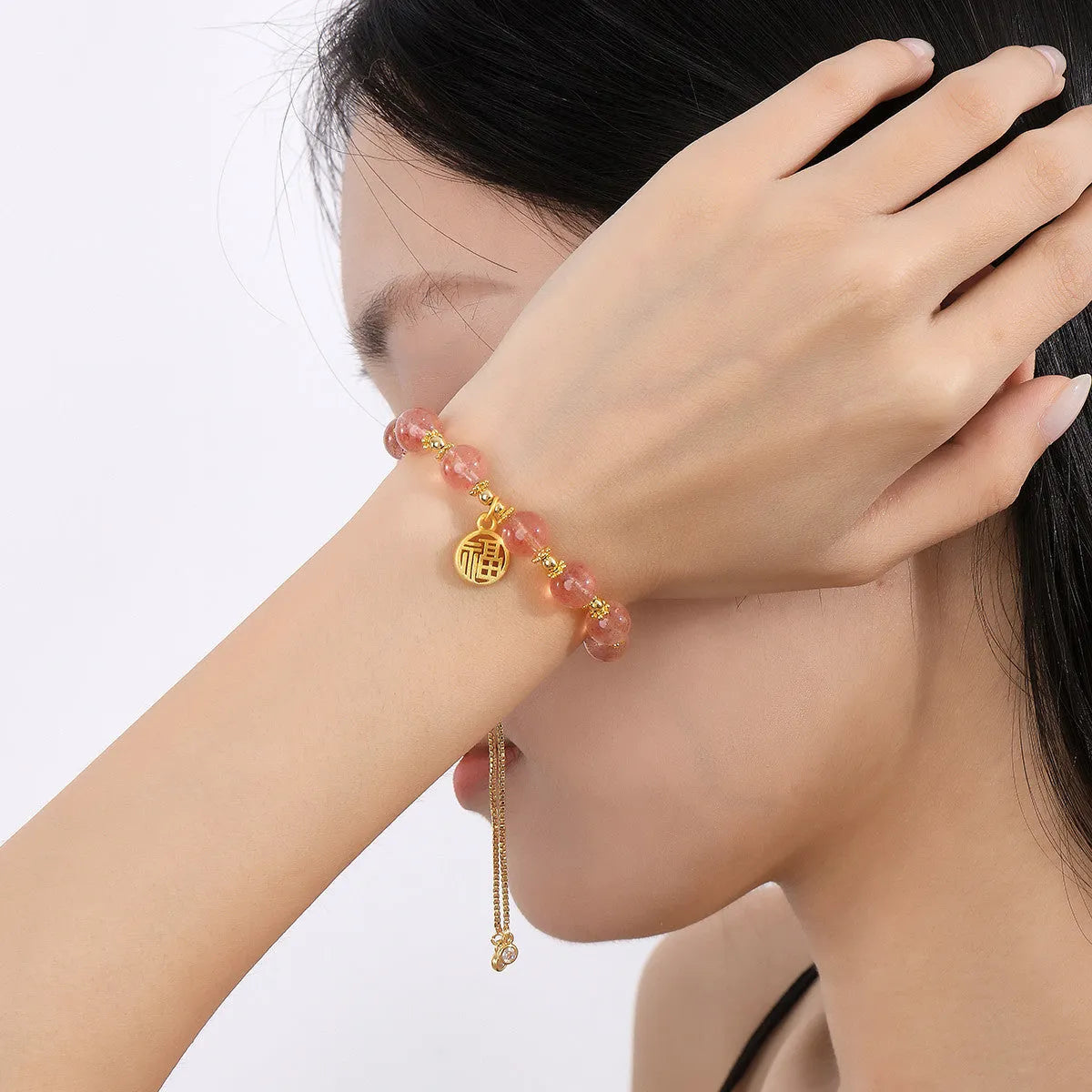 Women's Strawberry Quartz crystal bracelet with geometric shape and fu character design on an electroplated chain.