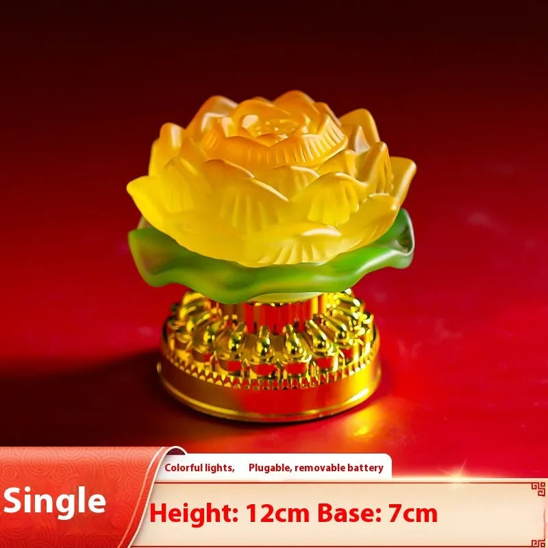 Yellow Chinese-style lotus lamp for Buddha altar decor on a table.